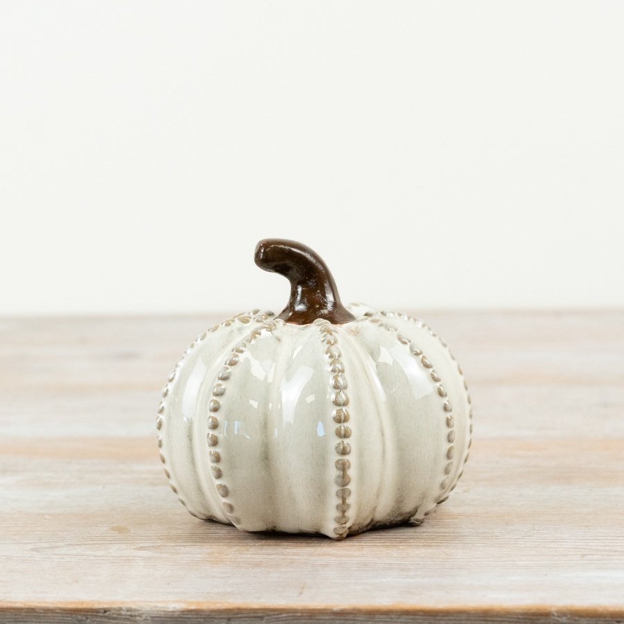 Elevate your interiors with this richly glazed and tonal pumpkin with raised details. 