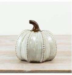 Bring cozy fall vibes to your Halloween decor with this delightful porcelain pumpkin ornament.