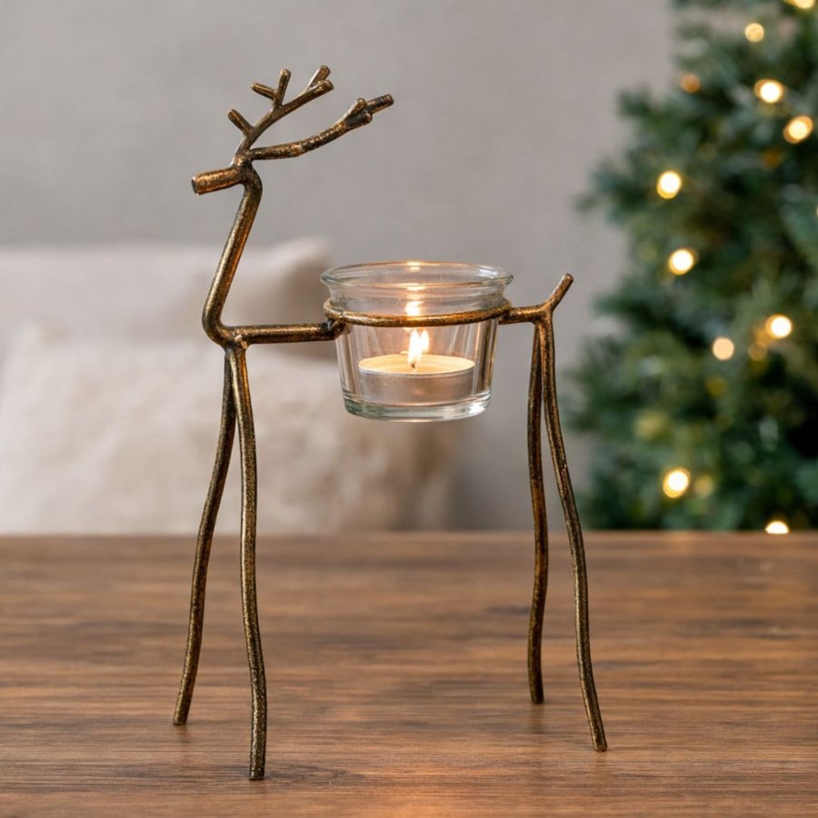 Add a warm festive glow to seasonal displays with this elegant antique gold reindeer t-light holder.