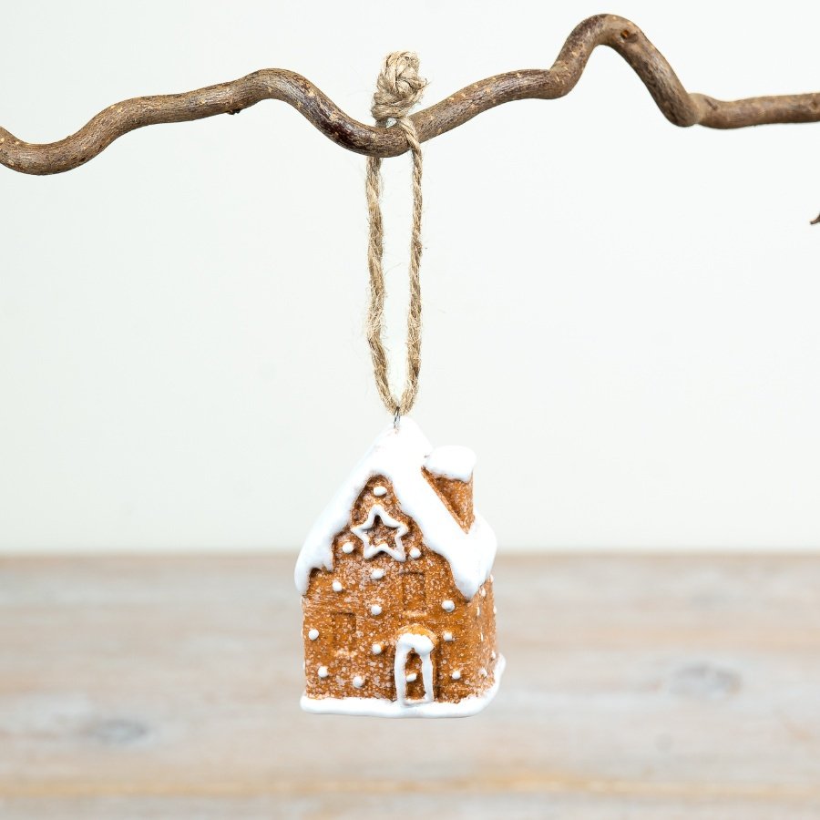 6.5cm ceramic gingerbread house hanger with classic icing details and a snowy roof design.