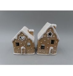 A festive ceramic gingerbread house featuring icing-style detailing