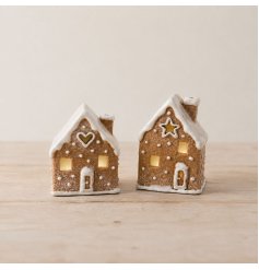Decorative gingerbread house features a natural biscuit-style finish with icing-style detailing.