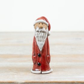 Crafted in ceramic with a timeless red and white finish, this 15cm Santa ornament brings classic Christmas charm 