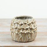 This 16cm stoneware planter features raised mushroom detailing with a soft reactive glaze in natural earthy tones. 