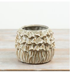 A characterful stoneware planter featuring detailed mushroom relief and a natural glazed finish