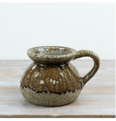 A decorative stoneware jug finished in a warm brown reactive glaze with natural stone detailing. I