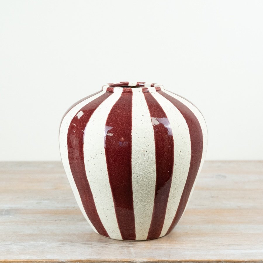 Make a bold statement in your interiors collection with this striking striped ceramic vase.