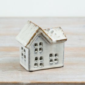 Add warmth and character to seasonal and everyday displays with this ceramic house t-light holder.