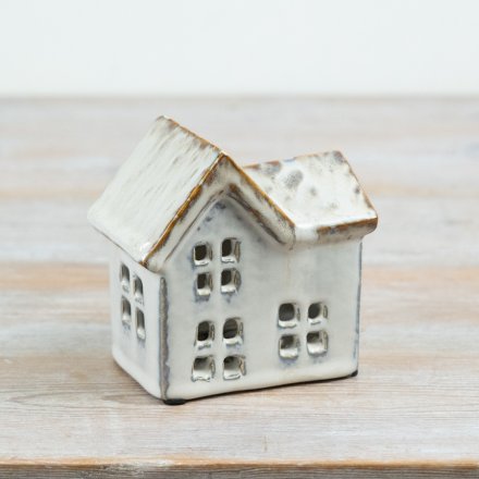Create a warm, inviting atmosphere with this ceramic house t-light holder.