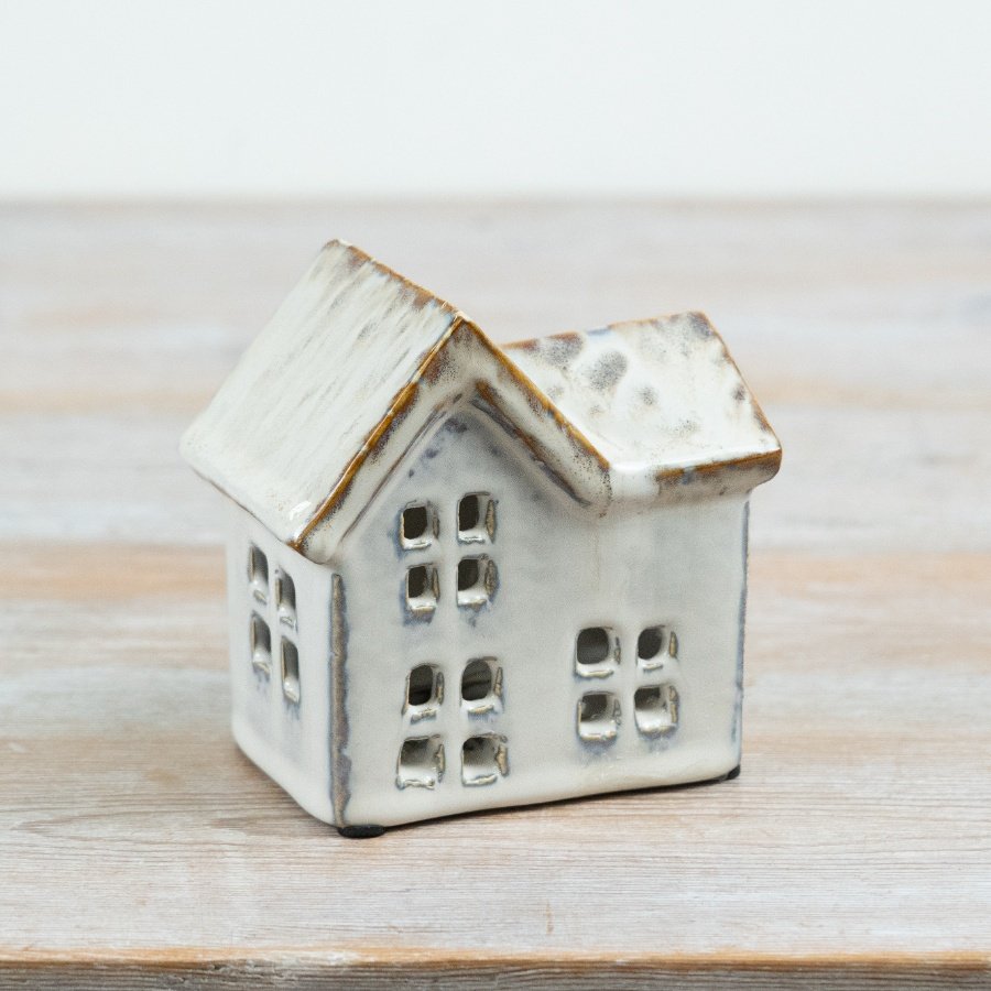 Add warmth and character to seasonal and everyday displays with this ceramic house t-light holder.