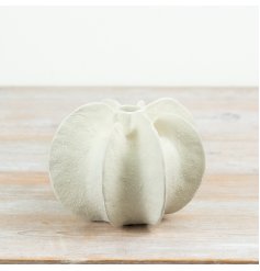 Made in a soft neutral shade, this modern design showcases sculpted segments and a textured surface.