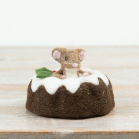A sweet mouse character sitting in a classic Christmas pudding with icing detail.