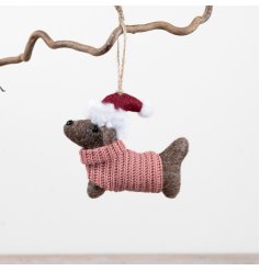 A characterful felt dog decoration designed for hanging on trees or garlands