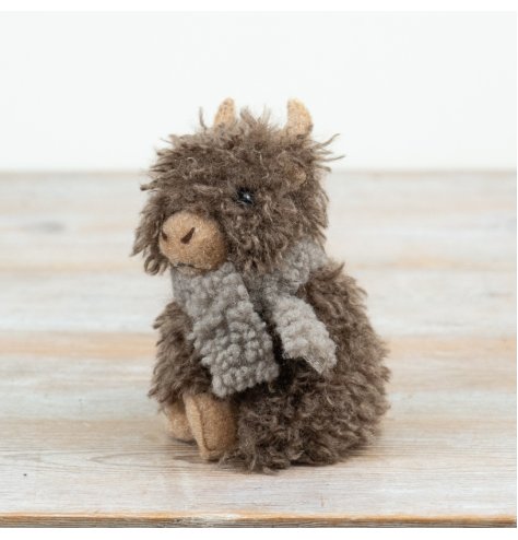 A charming Highland cow complete with textured fur and scarf detail. 