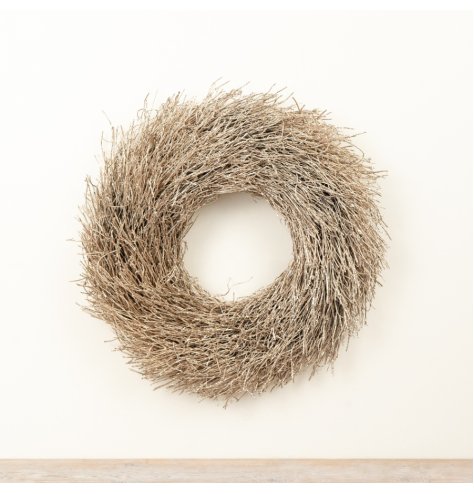 Add natural texture and gentle sparkle to your seasonal decor with this elegant decorative twig wreath.