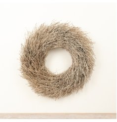 Bring natural texture and subtle sparkle to seasonal displays with this decorative twig wreath.