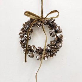 Wreath is crafted from a cluster of natural-style mini pinecones arranged around a circular frame