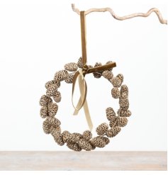 Champagne-gold pinecone wreath with a soft velvet ribbon, perfect for elegant hanging and decoration.
