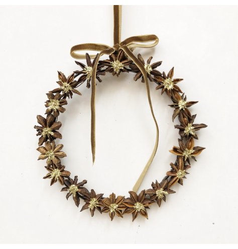 Decorative wreath of natural star anise pods, each with a subtle gold center for a warm, festive touch.