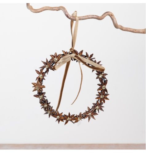 Decorative wreath of natural star anise pods, each with a subtle gold center for a warm, festive touch.