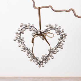 A decorative heart-shaped wreath crafted from metallic berry clusters set on a slim wire frame