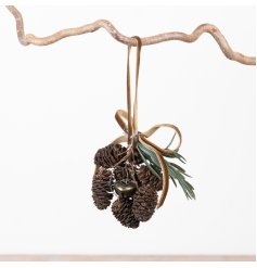 Rustic hanging decor with textured pinecones, aged jingle bells, and delicate faux greenery for a cozy touch.