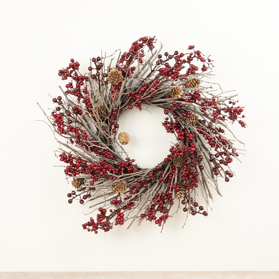 A striking seasonal wreath crafted from natural-style twigs, finished with clusters of deep red berries.