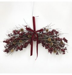 Hanging decoration features a rich arrangement of deep red berries combined with natural twigs and pinecones