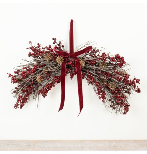 A festive hanging decoration featuring deep red berries.