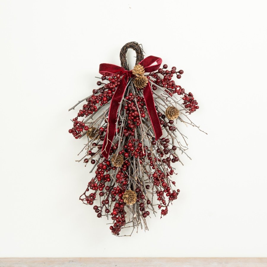 This 42cm festive hanging decoration features a rich red colour palette created with clusters of berries 