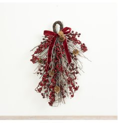 This 42cm hanging decoration features a traditional arrangement of red berries.