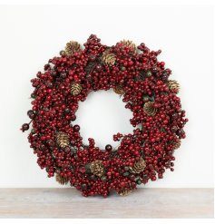 A classic Christmas wreath featuring a full arrangement of deep red berries