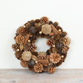 Wreath is crafted from an assortment of natural materials including pinecones, acorns, cinnamon sticks and berries