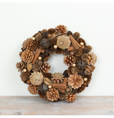 A festive wreath made with pinecones, acorns, cinnamon sticks and berries