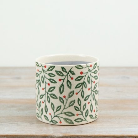 A charming 14cm ceramic planter featuring an all-over festive foliage pattern with green leaves and subtle red berries