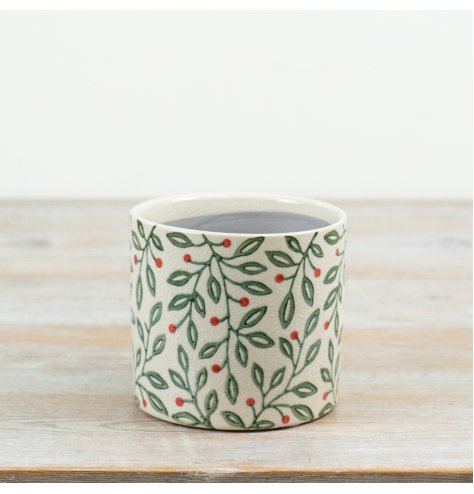 A decorative ceramic planter featuring a delicate all-over foliage design with green leaves and red berry accents.