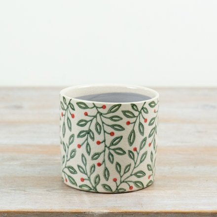 A charming 12cm ceramic planter featuring a festive foliage pattern with green leaves and subtle red berry detailing.