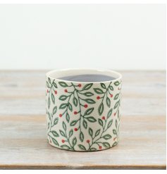 A charming 12cm ceramic planter featuring a festive foliage pattern with green leaves and subtle red berry detailing.
