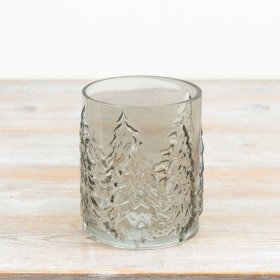 Smokey glass candle holder features beautifully embossed Christmas tree silhouettes around the glass
