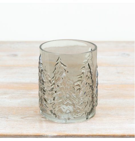 Smokey glass candle holder with embossed wrap-around Christmas tree design for festive décor.