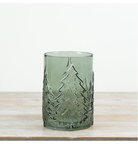 A tall green glass hurricane featuring embossed Christmas trees that beautifully enhance flickering candlelight. 