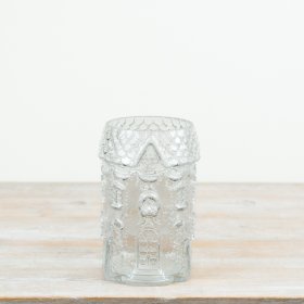 Gingerbread house vase features intricate embossed detailing inspired by traditional festive gingerbread houses