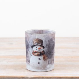 Delightful candle holder featuring a cozy winter snowman scene.
