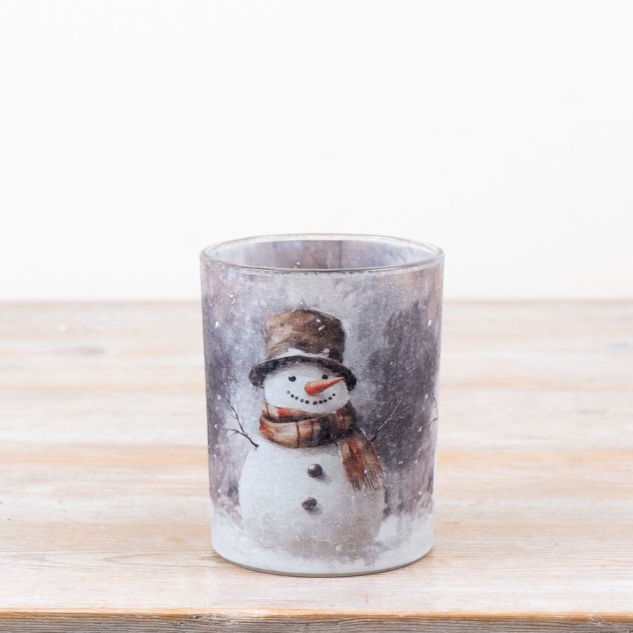 Delightful candle holder featuring a cozy winter snowman scene.