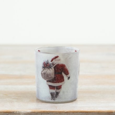 Create a warm festive glow with this charming glass candle holder featuring a classic Santa design. 