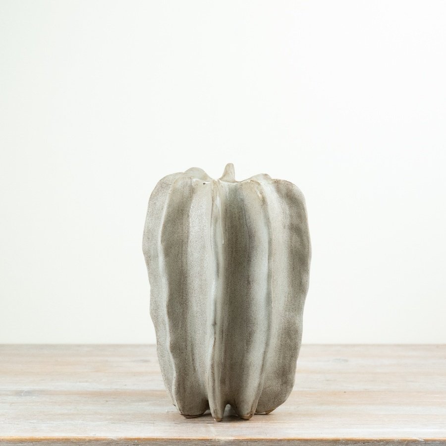 Crafted in stoneware with a softly contoured, free-form design,