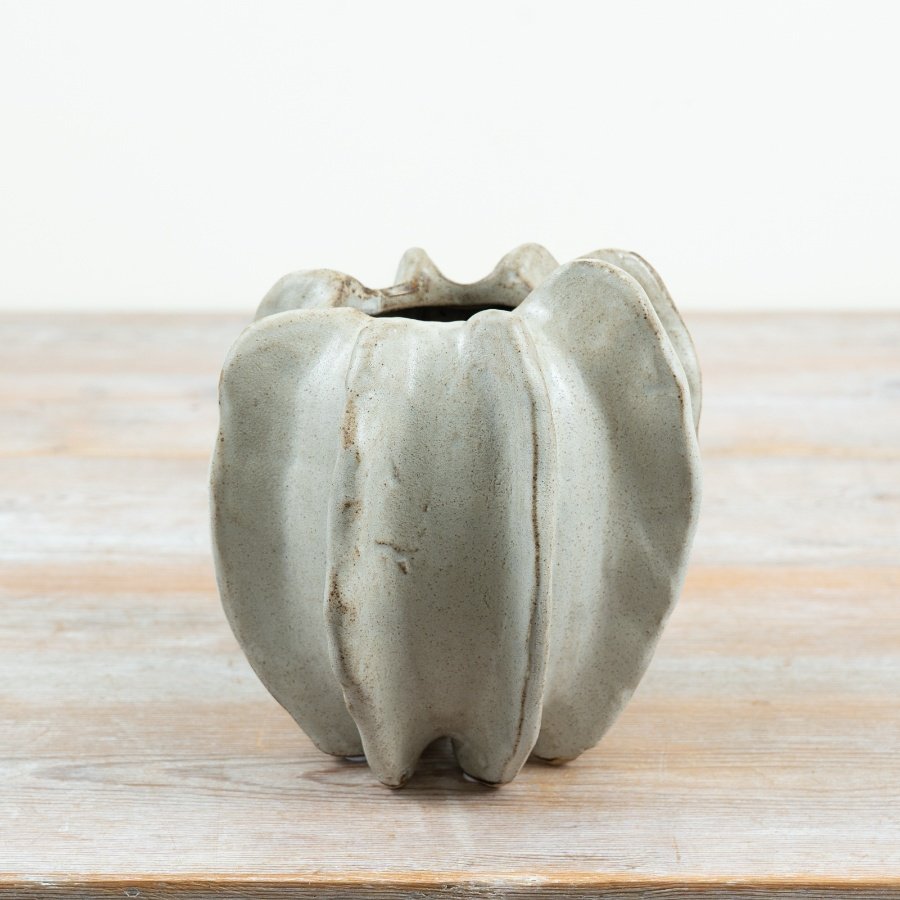 Crafted in stoneware with a softly contoured, free-form design,