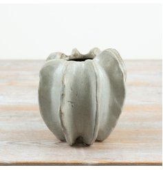 A compact 15cm stoneware vase featuring a sculptural, organic silhouette and soft neutral finish