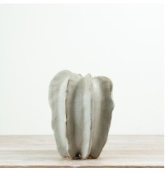 Featuring a fluid, ribbed silhouette and understated neutral glaze