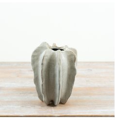 A striking 23cm stoneware vase with a sculptural, organic silhouette and soft neutral finish.